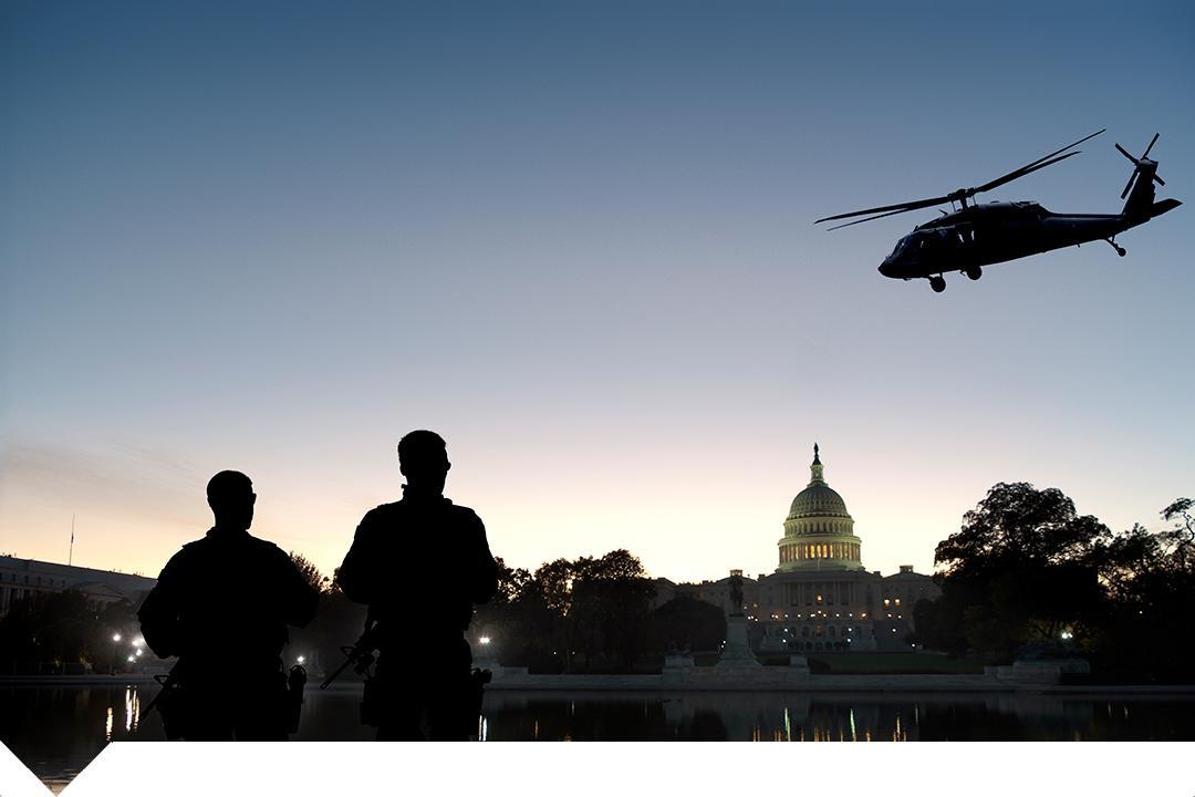 US Capitol with shadowy people and helicopter