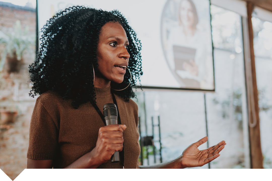Professional woman in brown jacket giving presentation
