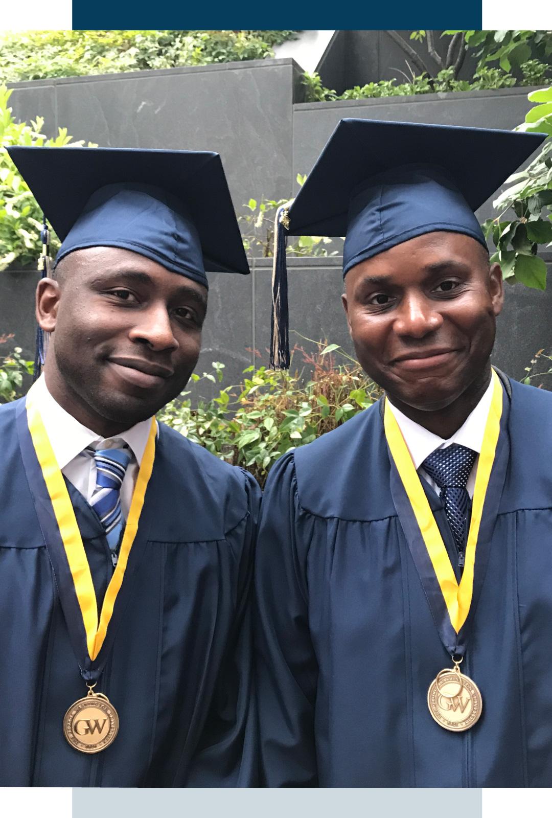 Two homeland security graduates in cap and gown